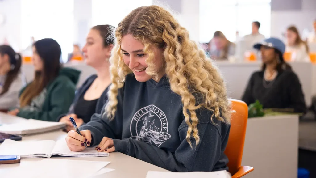 A female student taking notes during class
